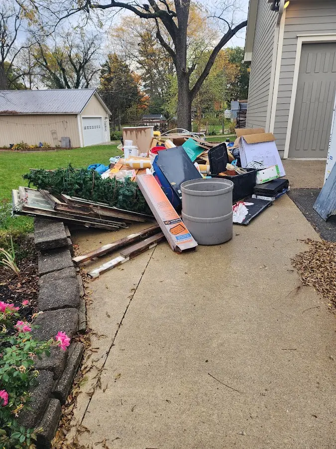 Dumpster being loaded with debris for Estate Cleanout Dumpster Rental in Merton